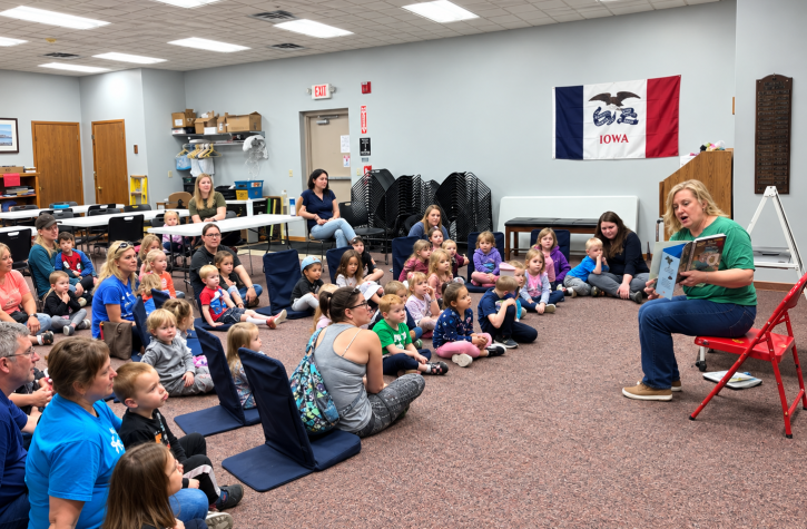 Mrs. Krista reading to children during storytime