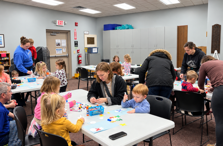 Families participating in a storytime craft